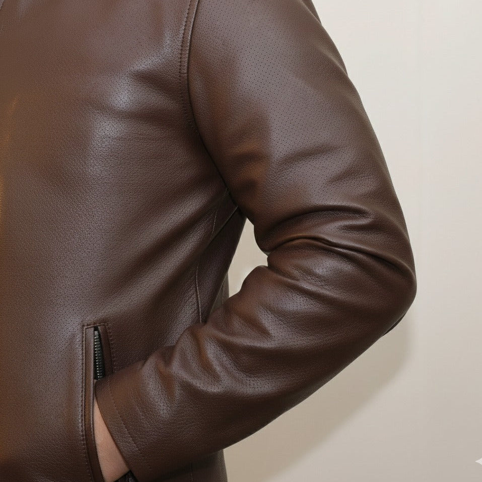 Close‑up of YKK zipper and lining on brown leather jacket