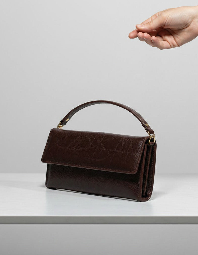 Front view of leather clutch with belt strap