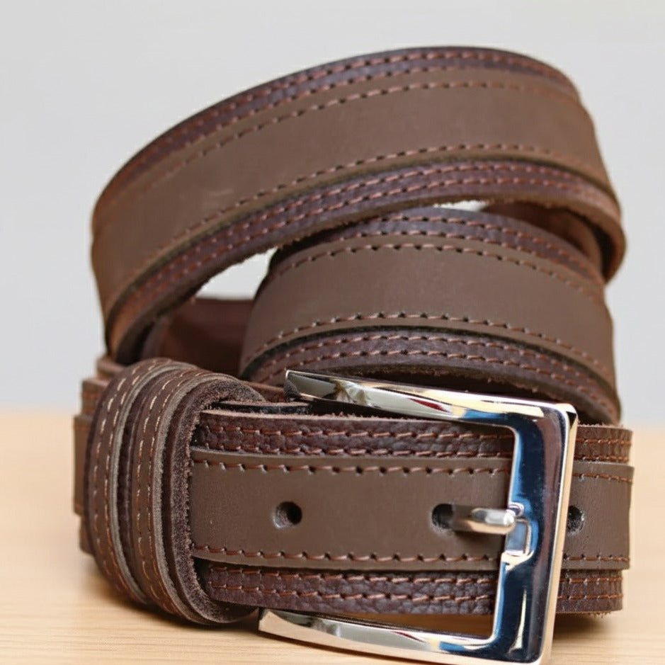 Close-up of brown leather belt with metal buckle