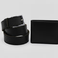 Slim black leather belt with metal buckle